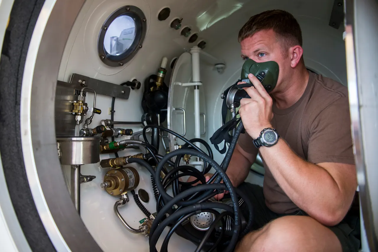 Diver breathing oxygen through a mask inside a decompression chamber